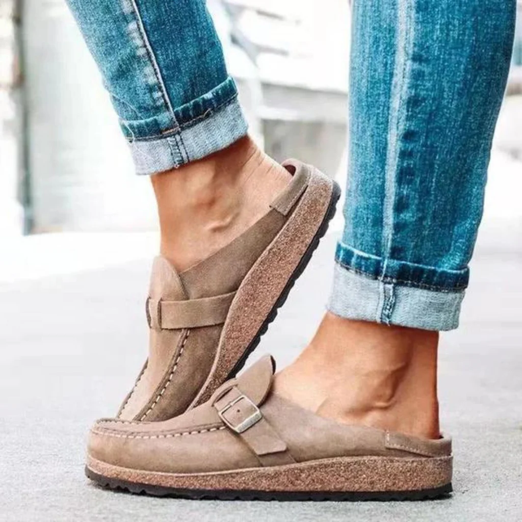Women's supportive orthopedic clogs with buckled strap, designed for foot health and everyday comfort.