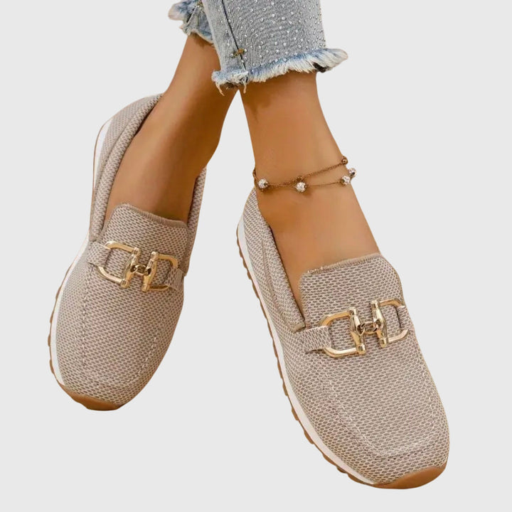 Elegant women's slip-on loafers with metal accent, orthopedic support & cushioned insoles.