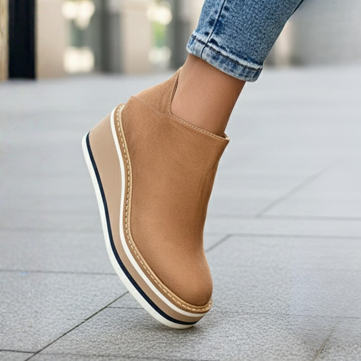 Durable women's orthopedic winter boots with a comfortable wedge heel and ankle height. Stylish round toe, easy to wear.