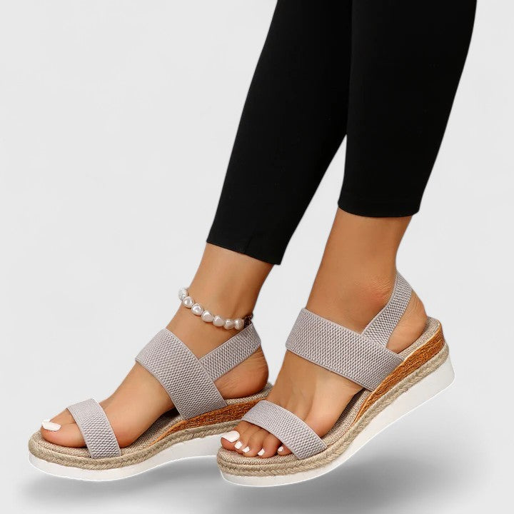 Supportive women's orthopedic sandals with a comfy wedge heel and open-toe for relief.