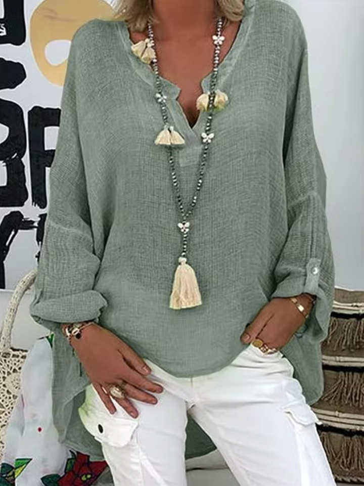 Stylish women's oversized flowy blouse. A versatile top for a chic, relaxed summer or casual elegant outfit.