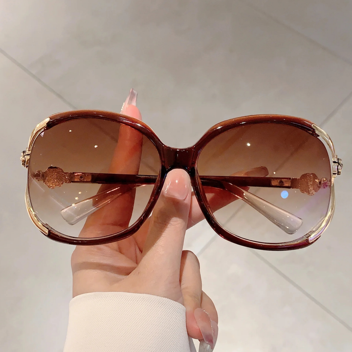 Purple oversized gradient sunglasses for women with delicate rose detail, fashion accessory.