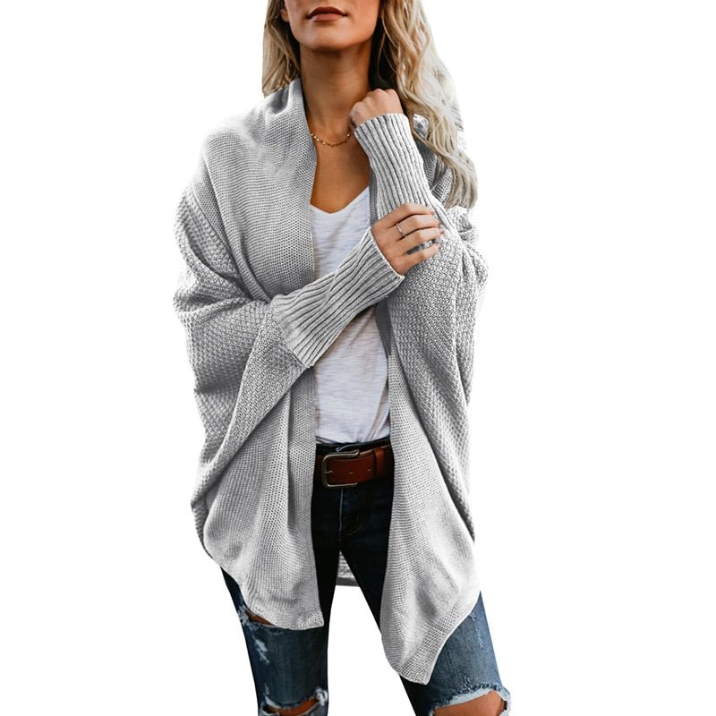 Warm women's oversized knit cardigan, a must-have fall essential for cozy layering.