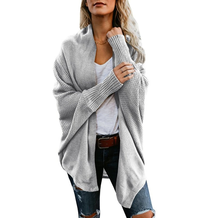 Warm women's oversized knit cardigan, a must-have fall essential for cozy layering.
