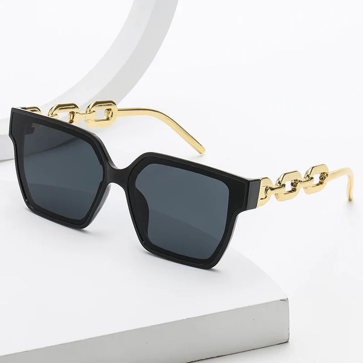 Women's oversized UV400 sunglasses with stylish chain link temples and metal frame for a fashion statement.