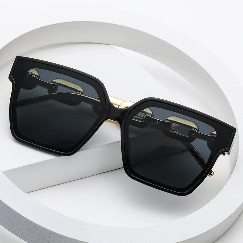 Fashionable women's oversized chain link sunglasses, offering UV400 protection with a chic metal frame.