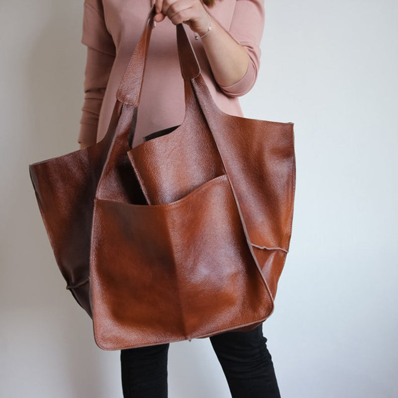 Woman carrying a stylish oversized travel bag, perfect for weekend trips.