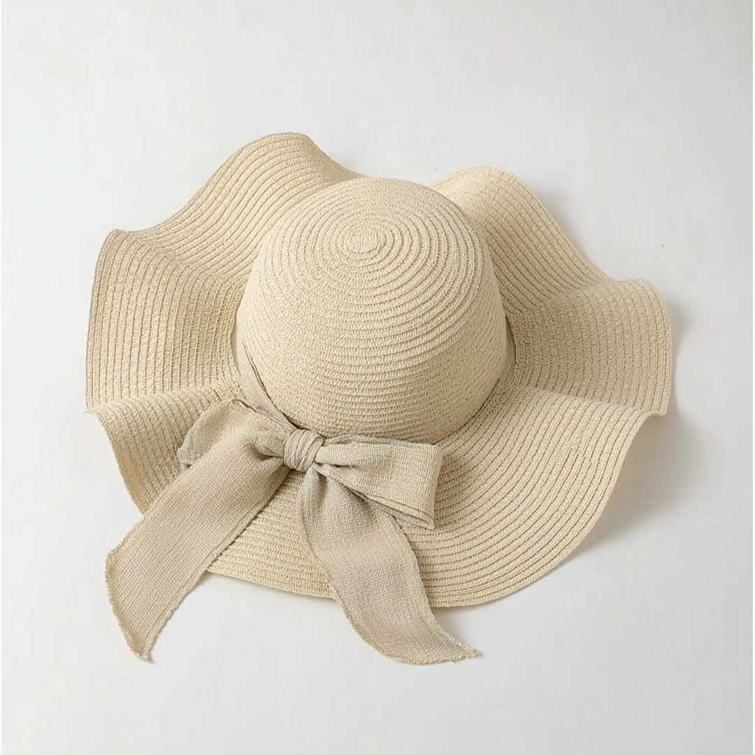 Floppy wide brim sun hat for women, oversized for maximum UV protection, a stylish summer & beach travel accessory.