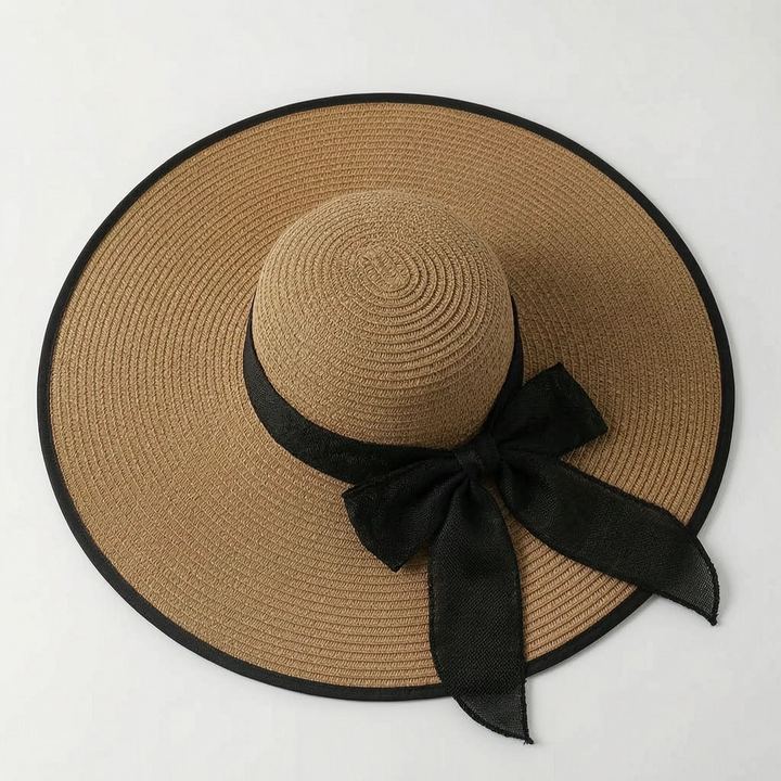 Elegant women's wide brim sun hat with oversized floppy design, perfect for stylish UV protection at beach or resort.