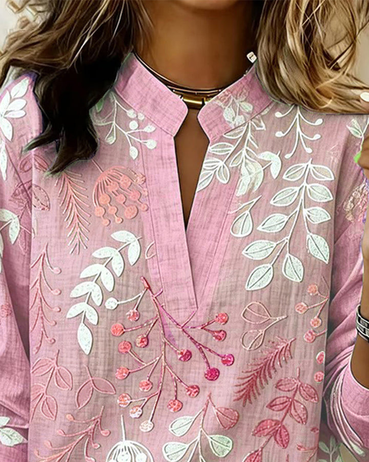 Elegant women's V-neck blouse with soft pastel floral print, suitable for various occasions.