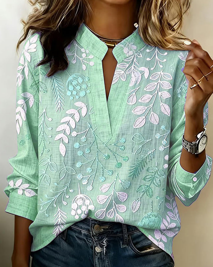 Spring/Summer women's floral V-neck blouse in beautiful pastel colors for a fresh look.
