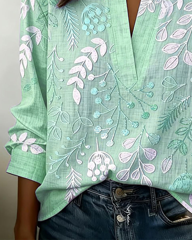 Stylish women's blouse featuring a pastel floral print and a flattering V-neck, lightweight.