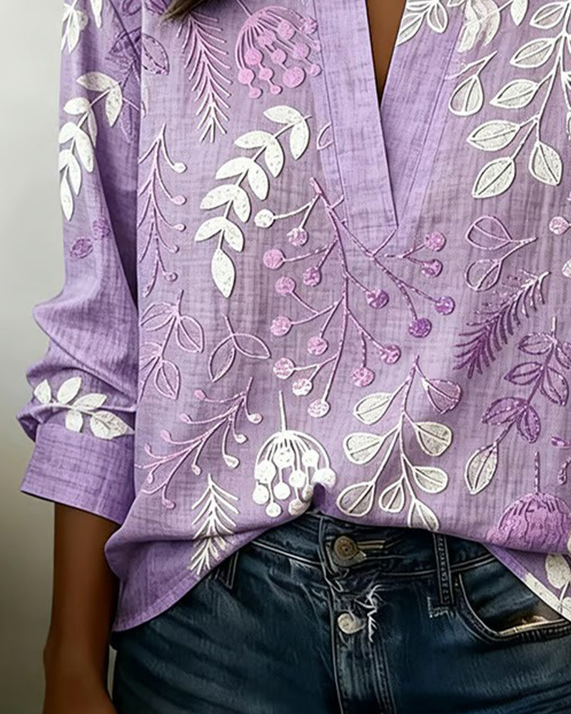 Chic women's V-neck blouse with delicate pastel floral print, perfect for elegant summer style.