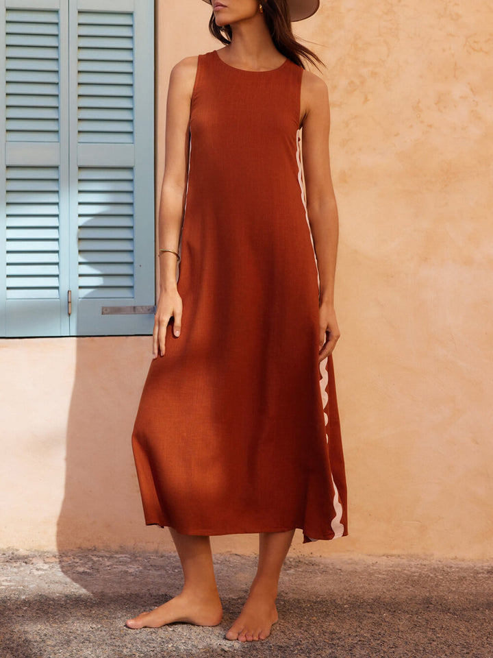 Stylish women's clothing: a pleated flowy midi sundress, ideal for elegant summer events or casual days.