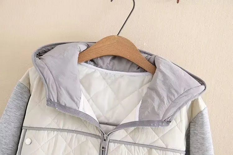 Detail of the diamond quilting and hood on a stylish plus size women's winter jacket.