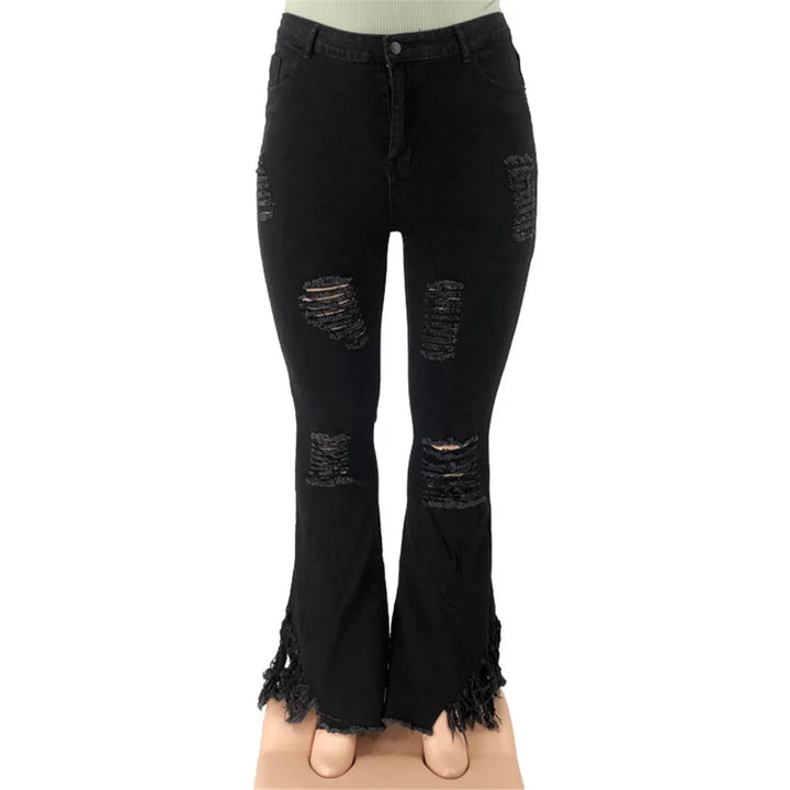 Plus size high-rise flared jeans with stylish rips, offering comfortable stretch denim for women.