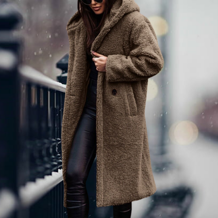 Detail of the soft plush fabric on a women's hooded winter coat, highlighting its luxurious texture.