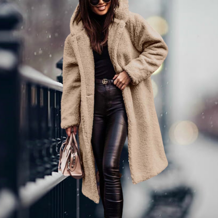 Women's warm hooded winter jacket, crafted from plush material for cold weather protection & style.