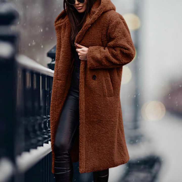 Fashionable women's plush winter coat with a cozy hood, designed for warmth in cold weather.