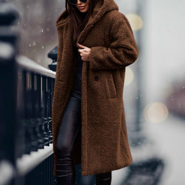 Warm women's winter coat featuring a plush texture and comfortable hood, great for elegant fall outfits.