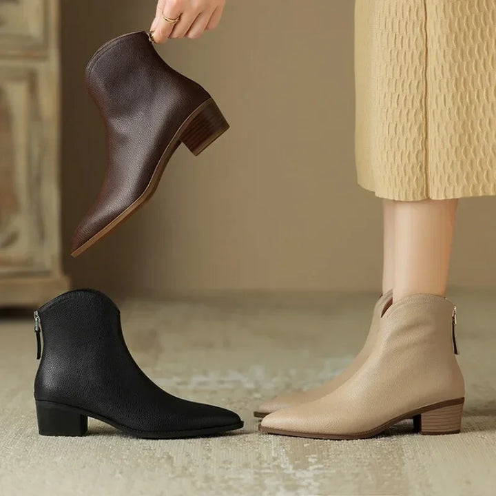 Fashion-forward women's pointed toe ankle boots, low heel, easy slip-on. Ideal for versatile winter wear.