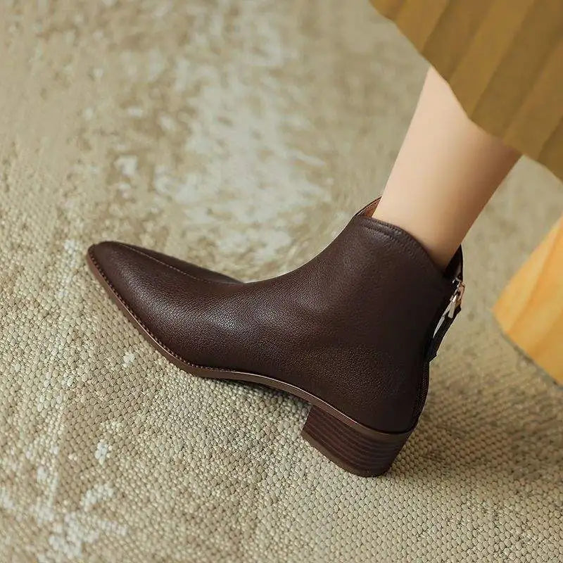 Professional women's pointed toe slip-on ankle boots with a comfortable low heel for office elegance.