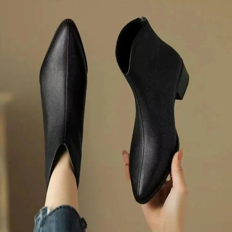 Elegant women's pointed toe ankle boots with low block heel & easy slip-on. Professional & stylish.