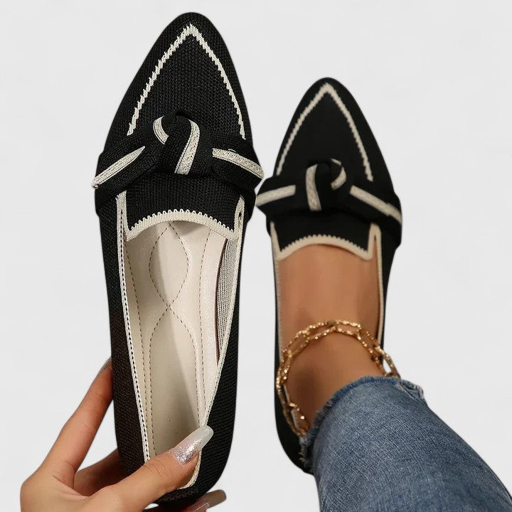 Close-up of women's pointed toe slip-on loafers, highlighting the elegant design and distinctive contrast trim.