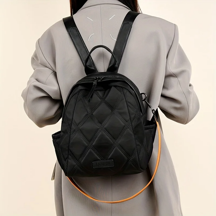 Durable women's quilted travel backpack, perfect for trips, easily converts to a shoulder bag.