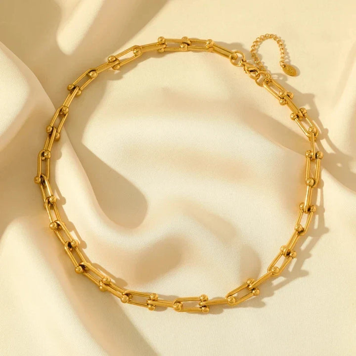 Polished gold link chain necklace, part of an elegant jewelry set for women's fashion.