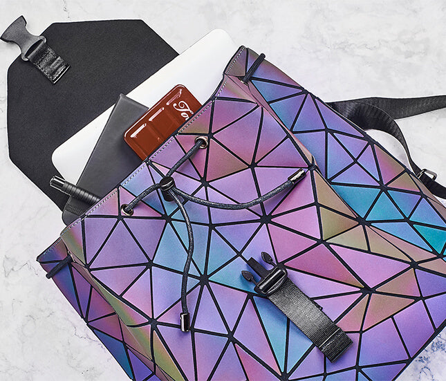Water-resistant women's reflective backpack, geometric design changes color in light.