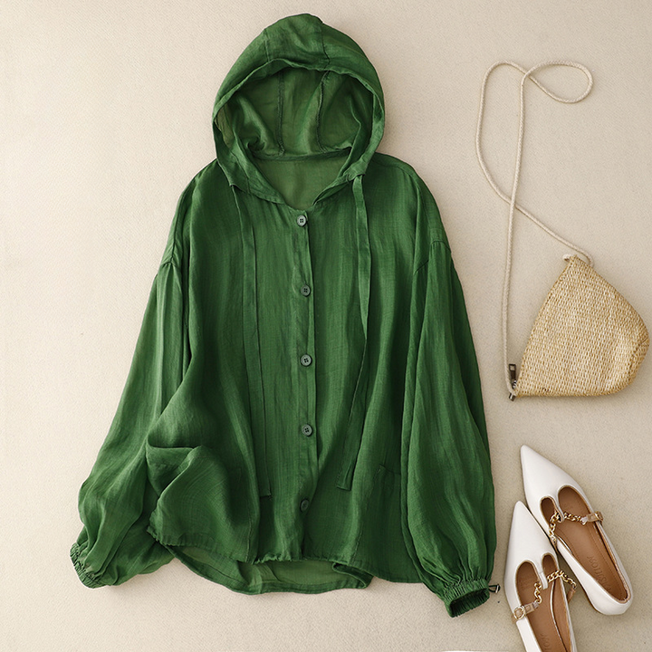 Close-up of women's relaxed hoodie with chic balloon sleeves and functional button front detail.
