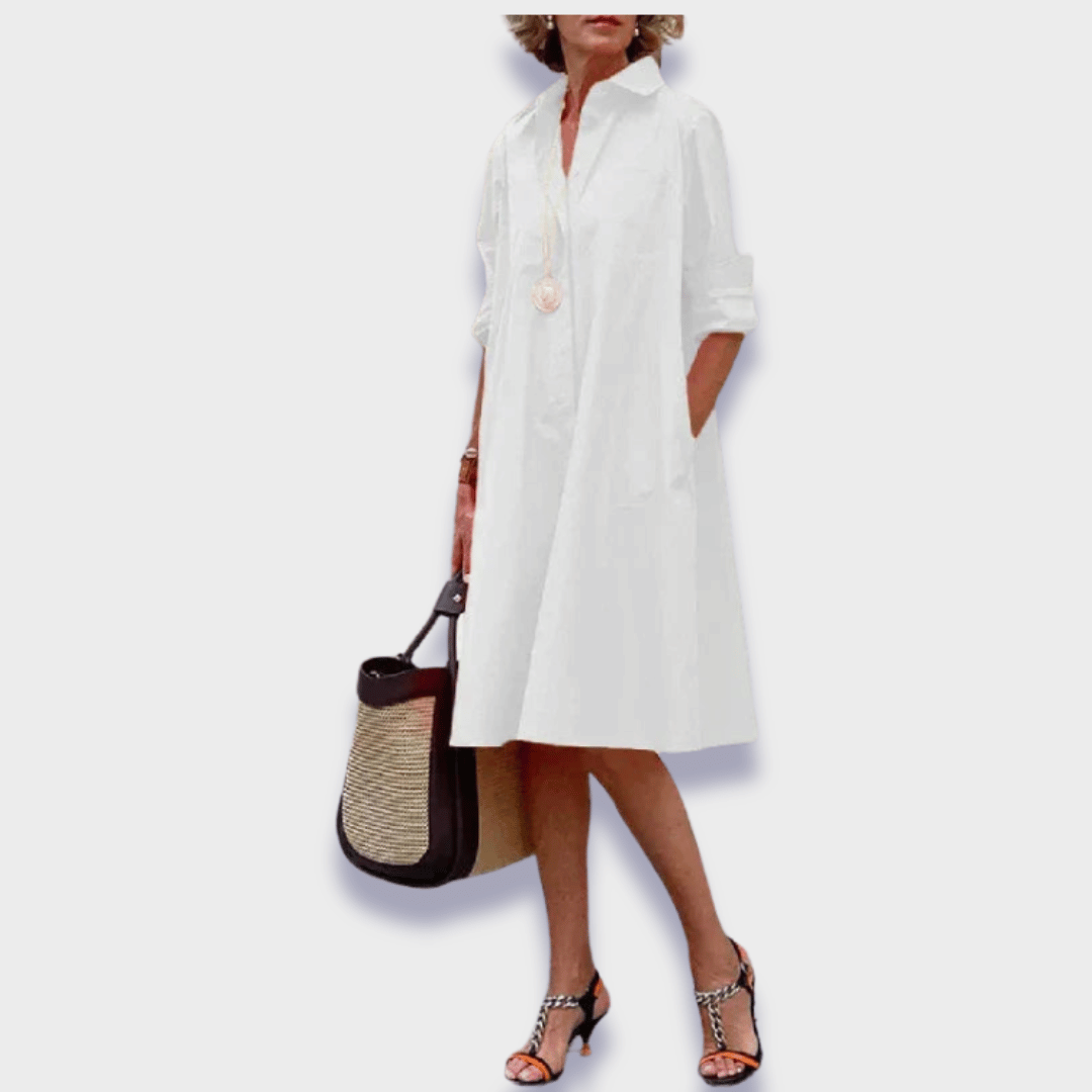 Elegant women's midi shirt dress. Features a relaxed button-up design, flowy silhouette, and functional side pockets.