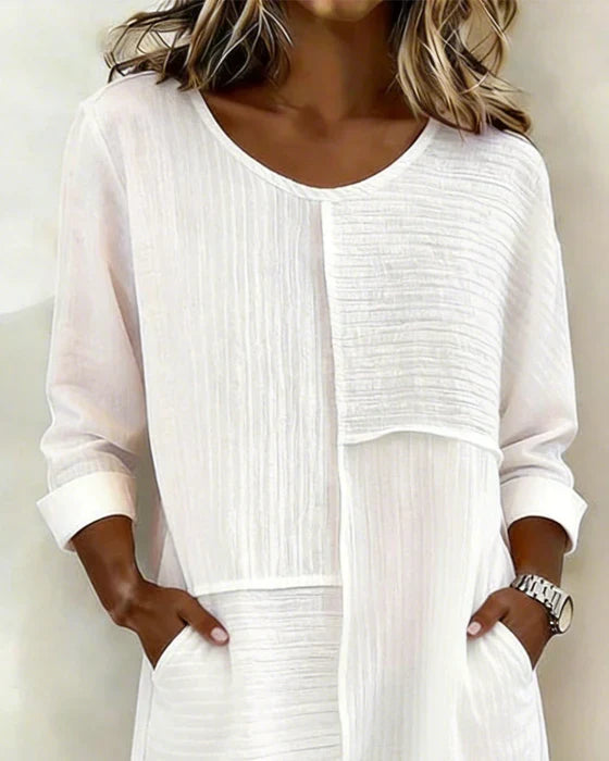 Chic women's shift dress with three-quarter sleeves and practical pockets. Ideal for spring & summer fashion.