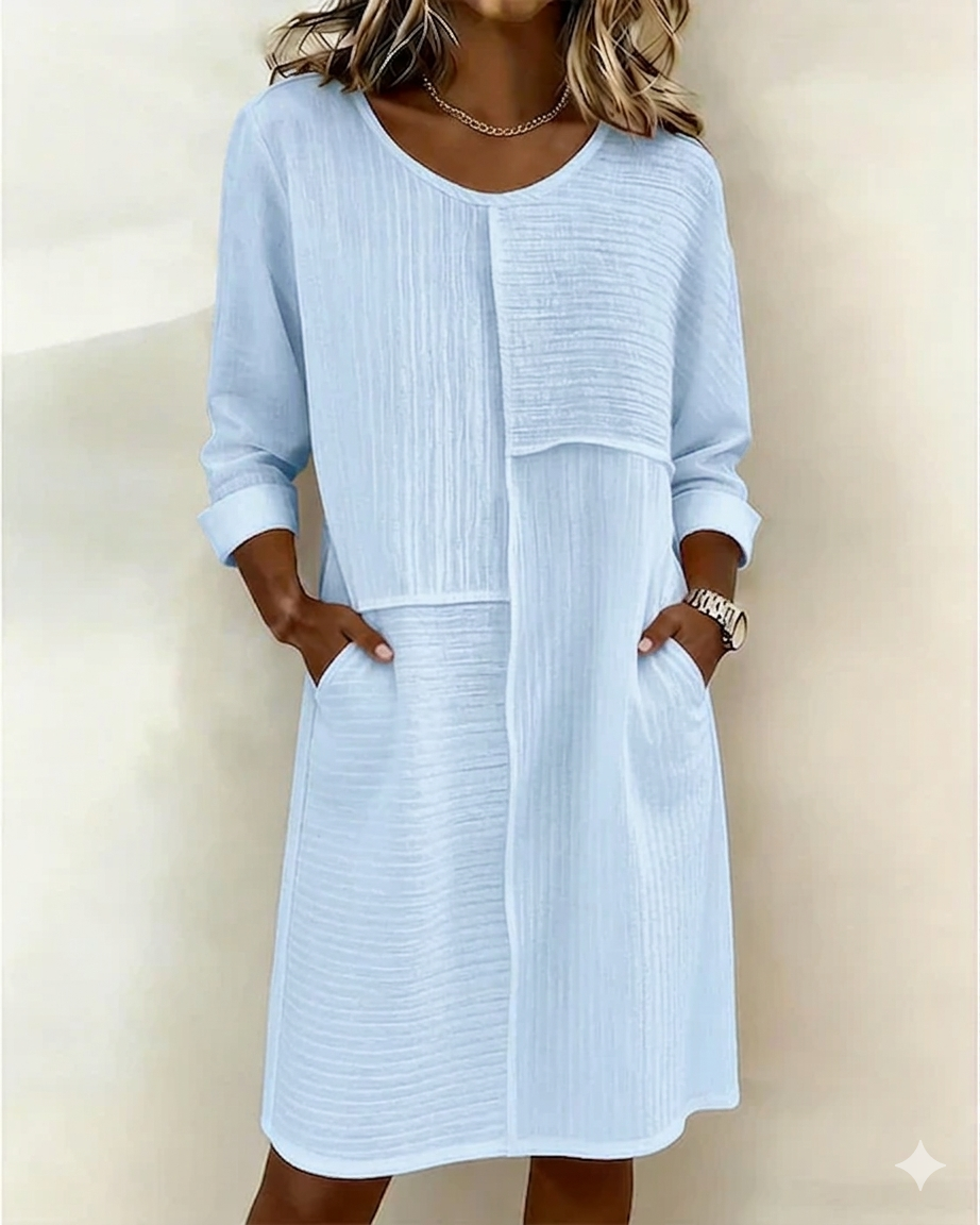 Stylish women's relaxed fit shift dress featuring three-quarter sleeves and convenient pockets. Casual yet chic.