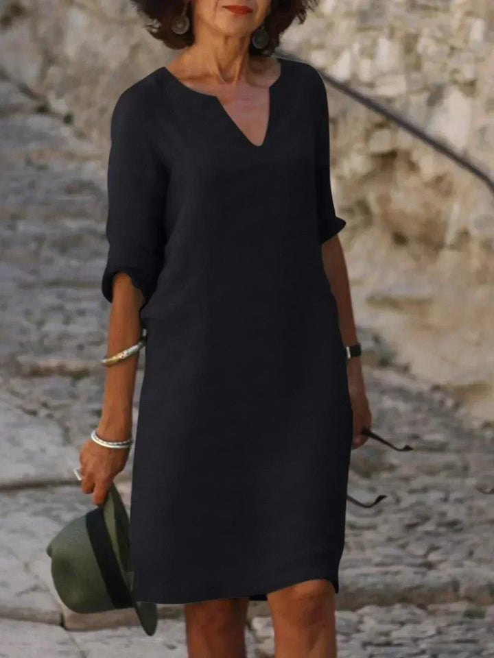 Women's relaxed fit V-neck midi dress with short sleeves and pockets, perfect for everyday summer wear.