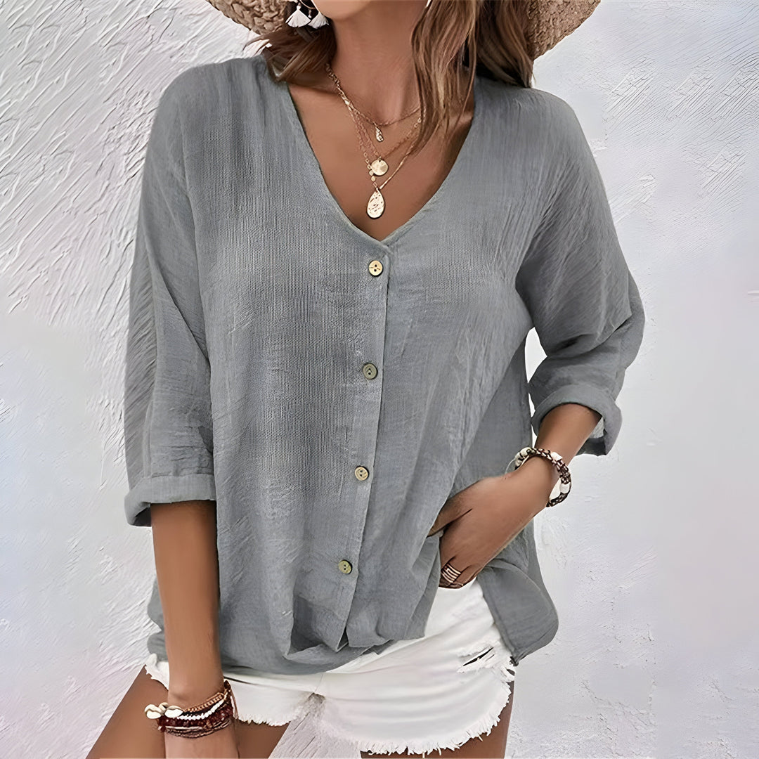 Relaxed V-neck button-down blouse for women, featuring roll sleeves. Perfect for comfy spring and summer outfits.