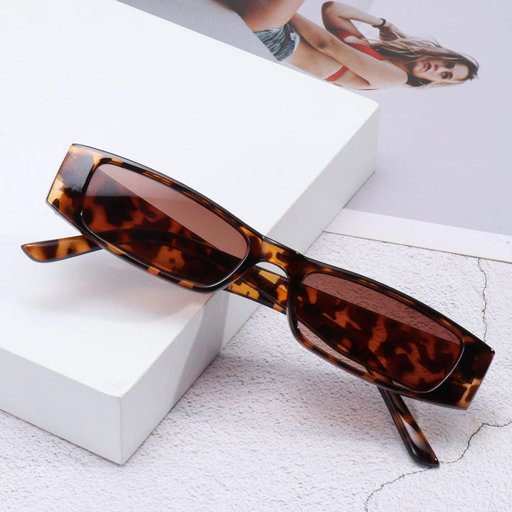 Polycarbonate women's retro slim shades, offering chic 90s style and reliable UV protection.