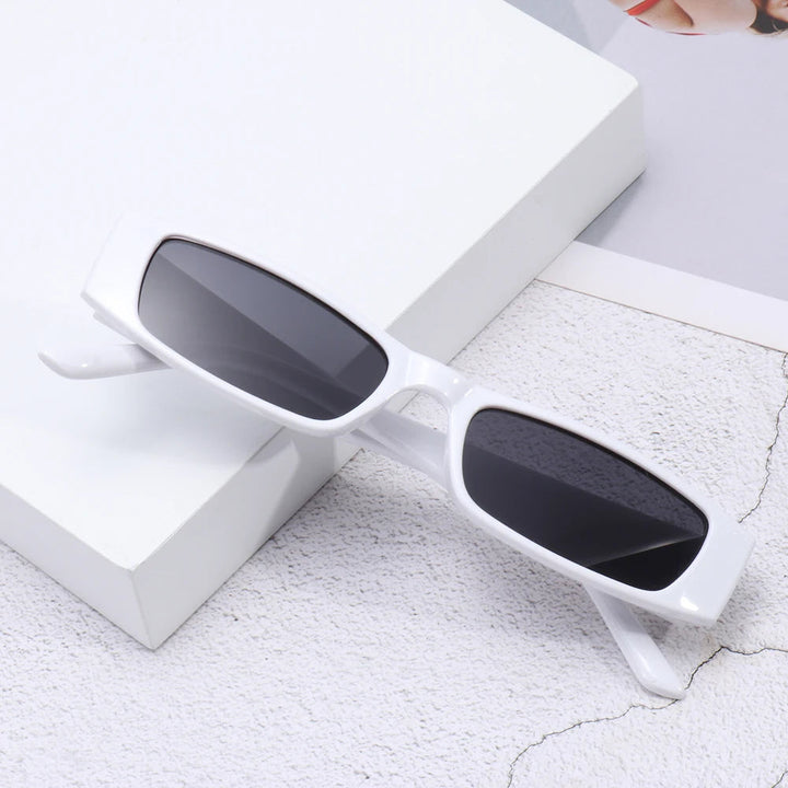 Fashionable women's retro slim shades, 90s inspired eyewear ensuring chic style & UV protection.