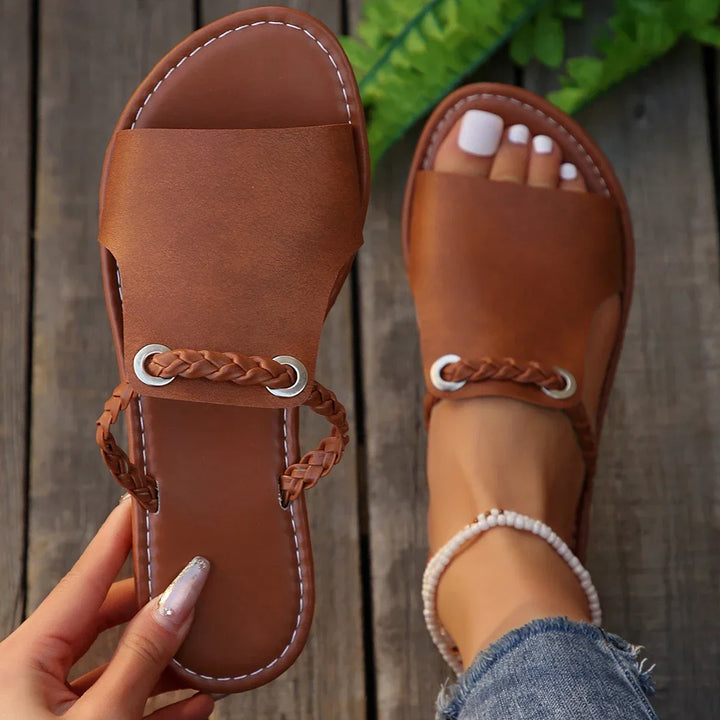Women's classic black braided slip-on flats, perfect for everyday summer comfort.