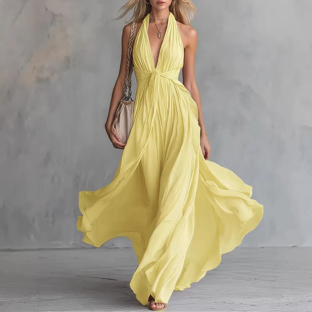 Pleated backless maxi evening dress for women. Flowy Roselyn formal gown with halter neck, perfect party attire.