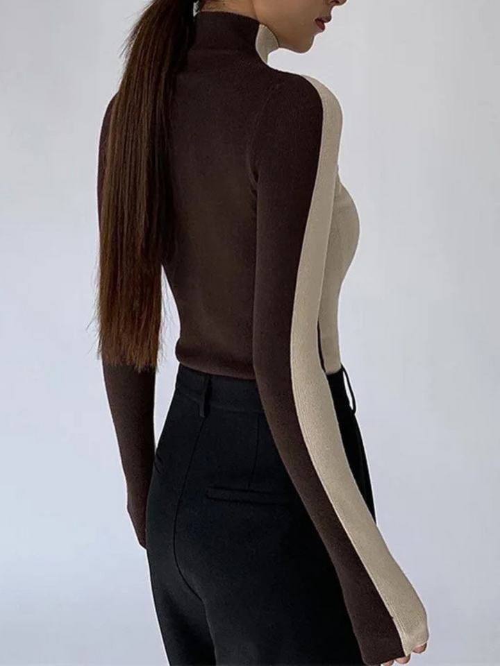 Modern women's sculpted contrast knit turtleneck sweater, elegant long sleeve design in stretch.