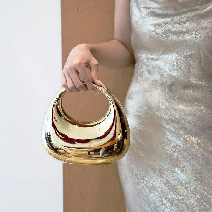 Elegant acrylic clutch bag, women's fashion accessory with a reflective mirror finish.