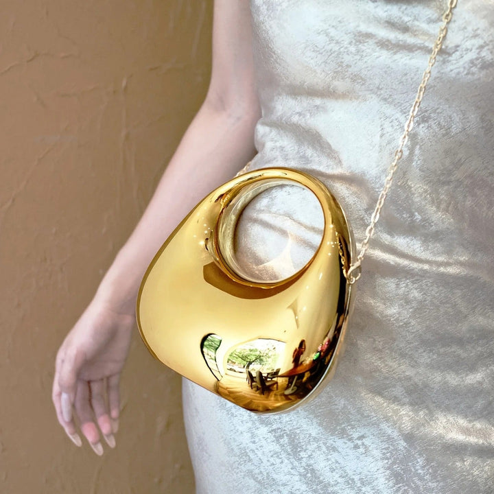 Statement women's evening bag, sculptural design with a dazzling mirror finish.