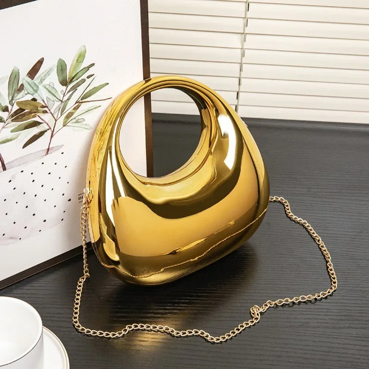 Acrylic sculptural clutch bag for women, featuring a stunning mirror finish.