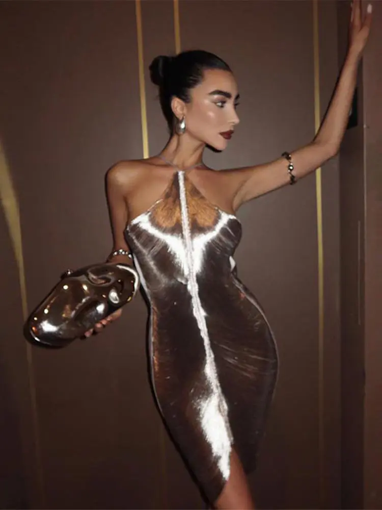 Elegant women's metallic mini dress in a shimmering silver fabric. Ideal for evening wear & glamorous fashion events.
