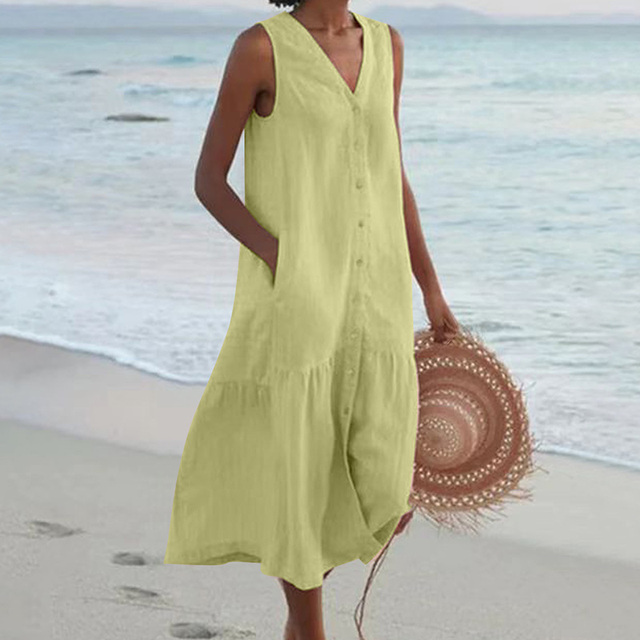 Woman wearing a chic sleeveless button-front midi dress, V-neck, styled casually for summer outings.