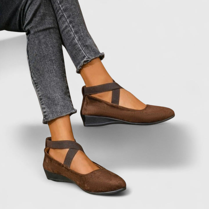 Close-up of women's cushioned orthopedic slip-on shoes, showcasing arch support & comfort for walking.