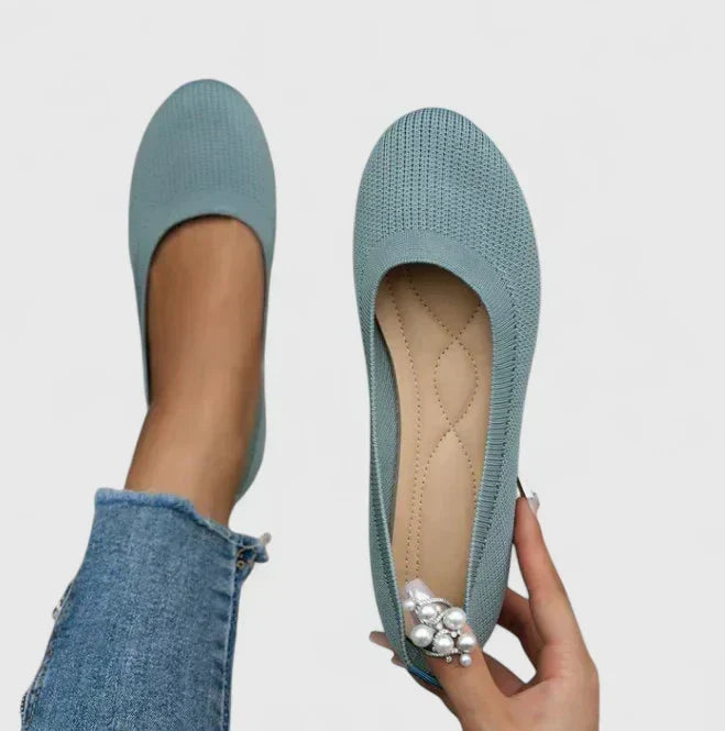 Side profile of a comfortable women's slip-on shoe, highlighting the robust arch support for walking & posture.