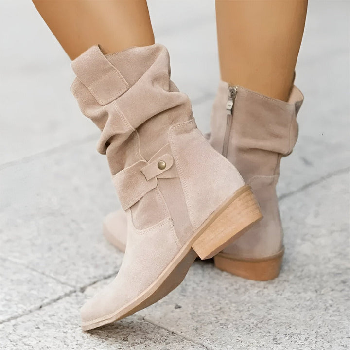 Comfortable women's slouchy ankle boots featuring a low heel and decorative buckle strap.